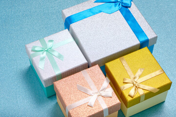 Holiday gifts in gift boxes blue shiny background.