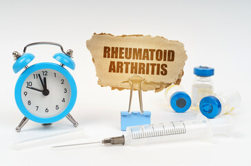 Near the stethoscope are a syringe, ampoules and a clip with a cardboard plate - Rheumatoid...