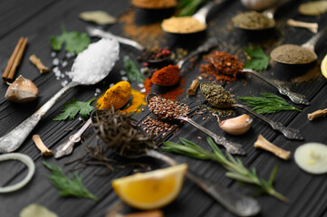 Colorful various herbs and spices for cooking on dark wooden rustic background