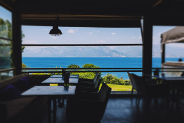 Terrace cafe or restaurant with scenic views of sea and mountains