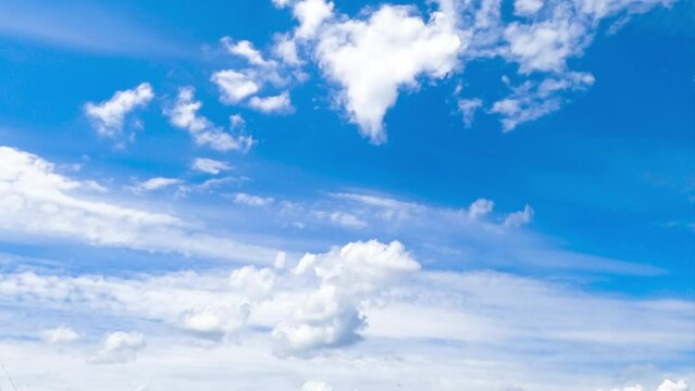 Heavenly beautiful blue skies with white clouds floating by. Cumulus and spindrift clouds transforming in the atmosphere. Timelapse.
