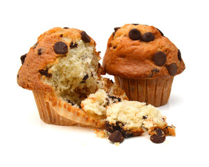 Stack light chocolate chip muffins in wax liner on white.