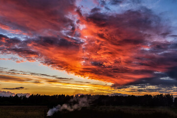 Fototapeta na wymiar Dramatic evening red sunset sky with clouds