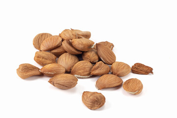 Peeled apricot kernels on bright background. Close up view.