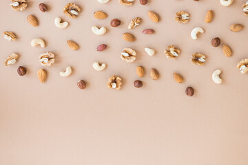 nuts mix for a healthy diet cashew, peanut, hazelnuts, walnuts, almonds on brown background