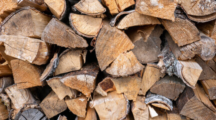 Fototapeta premium Harvesting firewood for the winter. A supply of firewood for heating the house in winter. Stacked firewood close-up.