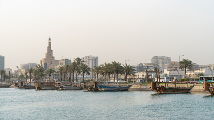 Doha, Qatar- Multiple wooden fishing dhows docked in the doha corniche.