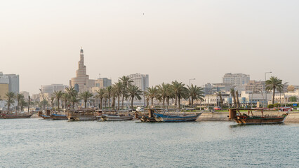 Doha, Qatar- Multiple wooden fishing dhows docked in the doha corniche.