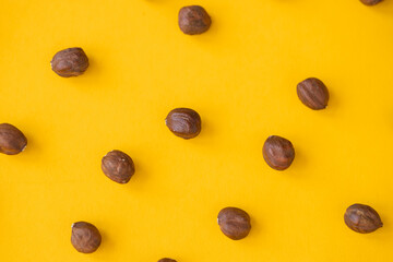 Hazelnut isolated. Hazelnuts on yellow background. Hazel top view. With clipping path.