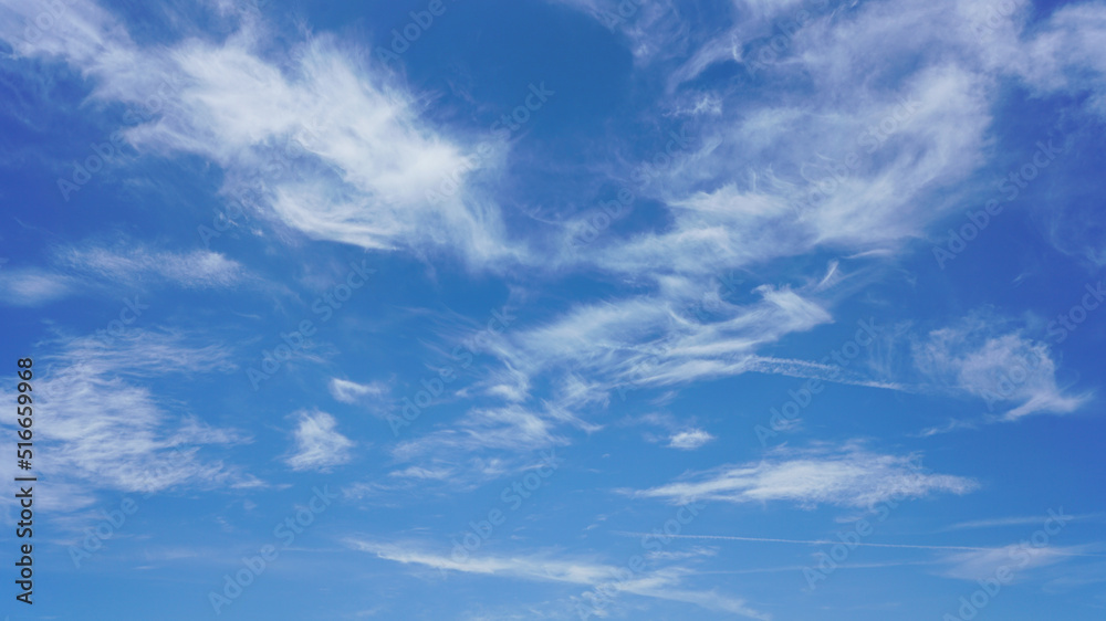 Wall mural wispy clouds and blue sky suitable for background use or sky substitution