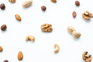 Pattern of nuts mix. Cashew, peanut, hazelnuts, walnuts, almonds on white background