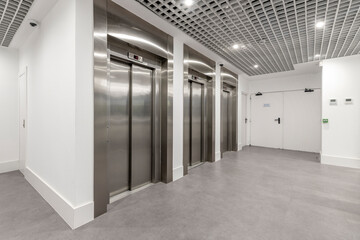Stainless steel elevator bank in the lobby of an office building