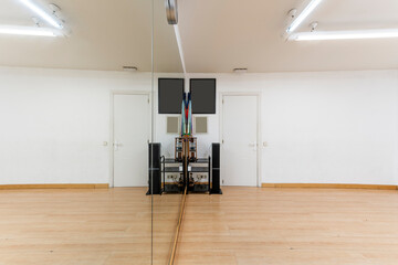 Exercise room with hardwood floors and a mirrored wall and stereo with speakers