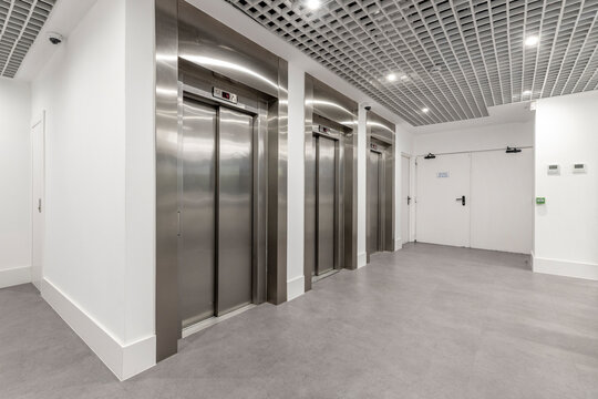 Stainless Steel Elevator Bank In The Lobby Of An Office Building