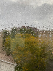 Closeup - heavy rain drops on the window and screen during hurricane 