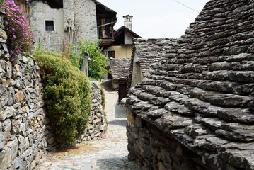 Fototapeta na wymiar Monte Ossolano, Province of Verbano-Cusio-Ossola, Italy - 06 19 2022: Monte Ossolano, the fantastic village of stone houses