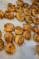 A variety of bread products with sesame: buns, pretzels, poppy seed buns for sale in a bakery