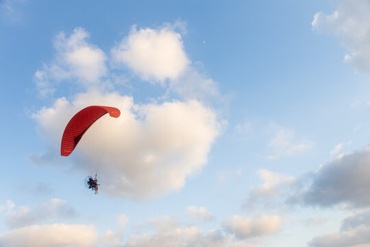 Motor hang glider in the blue morning sky at desert