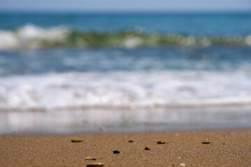 Blurry waves as a background on the sandy coast of Crete