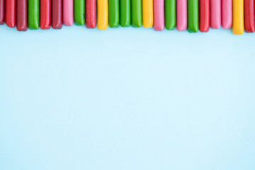 Candy colored sticks on blue background