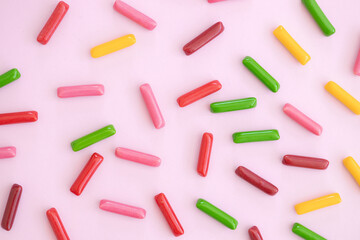 Candy colored sticks on pink background
