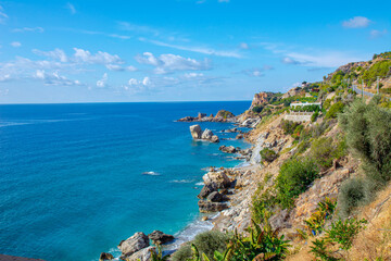 Fototapeta na wymiar Beautiful view of the sea and rocky steep coast with banana trees