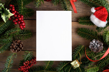 Christmas 5x7 card mockup template with fir twigs and Christmas decoration on wooden background....