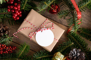 Blank round Christmas gift tag mockup with present box, product label mockup, with natural fir tree branch, cones and Christmas decoration, Christmas sale concept