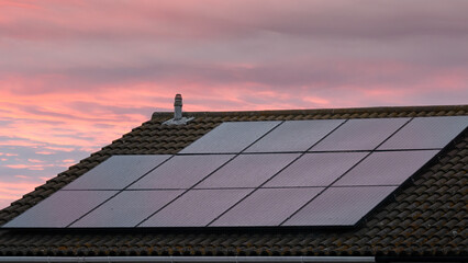 Roof with solar panel  against dawn sky