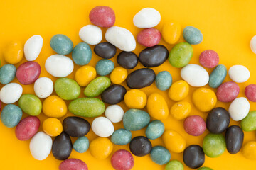Colorful Chocolate Candy Pills Isolated on yellow Background