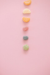 Fototapeta na wymiar Italian jelly fruit sweets on pink background