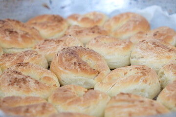 Close-up and some blurred freshly baked pastry with sesame in the oven. 