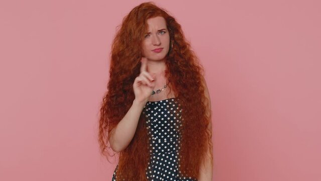 I am dont want it, not me. Confused redhead woman pointing fingers herself ask say who why me no thanks i do not need it, rejection, refusal, stop sign. Ginger girl with freckles on pink background