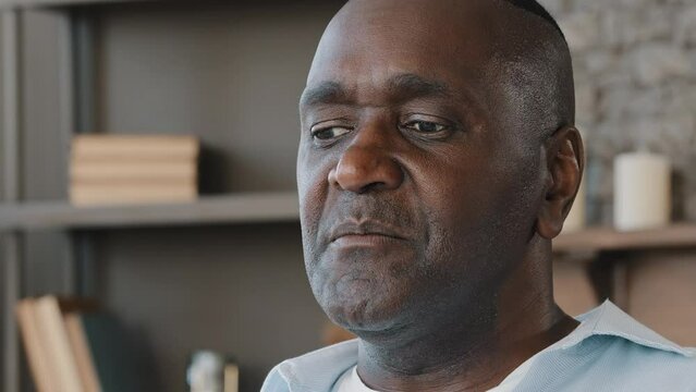 Elderly african american adult 50s man portrait senior grandpa businessman leader saying story talking information to somebody reads verse repeats rules explain details recall memory tell presentation