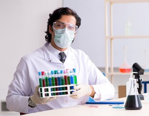 The young handsome chemist working in the lab