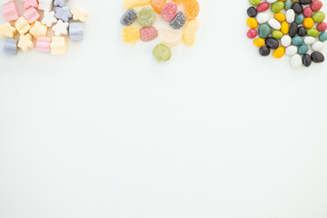 many different candies, sweets on white background