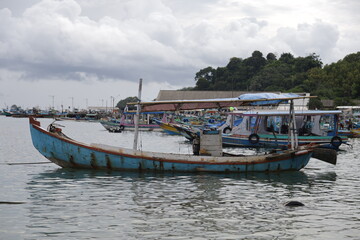 Fototapeta na wymiar A beautiful shot of a fishing boat on the seashore. Old wooden row boat moored