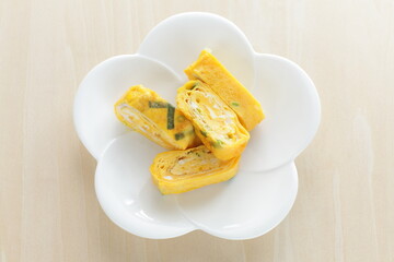Japanese food, green onion in fried egg roll on white dish for comfort food image