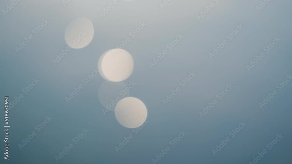 Poster abstract summer bokeh background with moving sun glare over the flow of water in the river