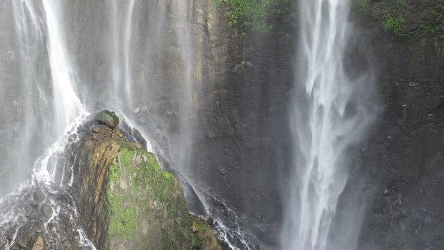 Fairy waterfall at wild forest. Wonderful fresh water waterfalls river flowing.  Panoramic sun landscape of nature waterfall. Fresh nature. tumpak sewu waterfall. 4K