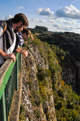 Naklejka premium People looking down from the cliffside platform at Gelain Lookout in Flores da Cunha, Rio Grande do Sul, Brazil
