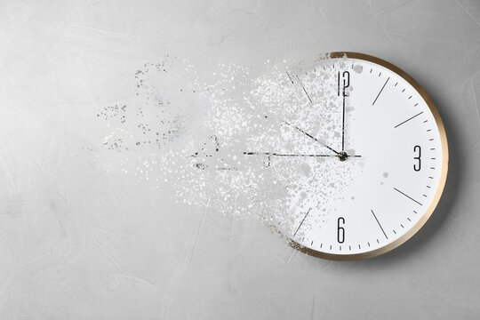 Time is running out. Clock vanishing on light background