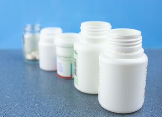 Jars with medicines on a blurred background in the distance. The concept of boxes of jars of medicines.Medical drugs in jars.