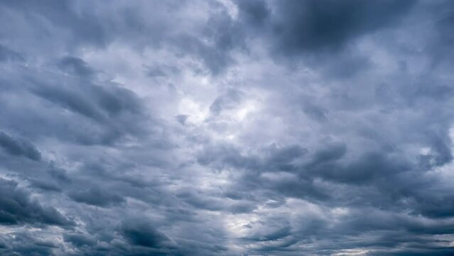 Timelapse of dramatic storm clouds moving in the sky. Dark cumulus clouds change their shape in cloud space. Scenic sky. Dramatic atmosphere background, time lapse. Change of weather. Nature. 4K