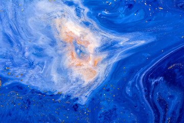 Luxury fluid art painting background. Spilled blue, white and gold acrylic paint. Liquid marble.