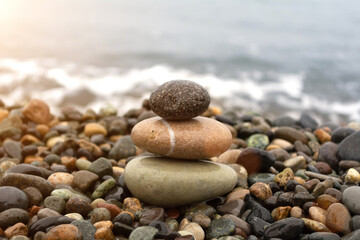 Three pebbles on each other at a beach.