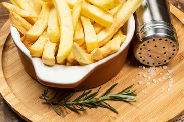 Tasty french fries on plate on bowl
