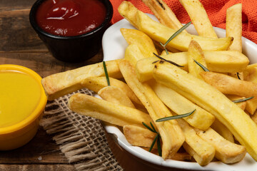Tasty french fries on plate on bowl