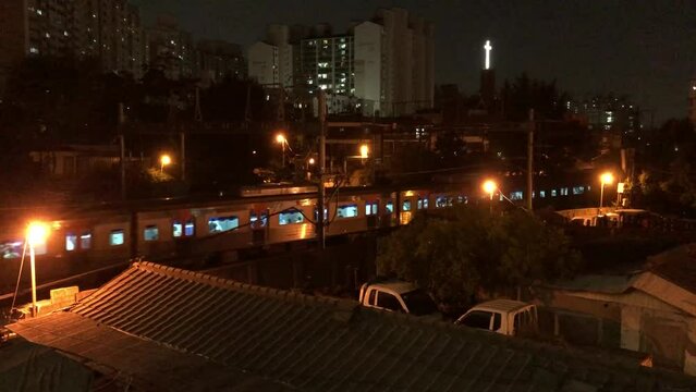 subway train goes along the tracks at night