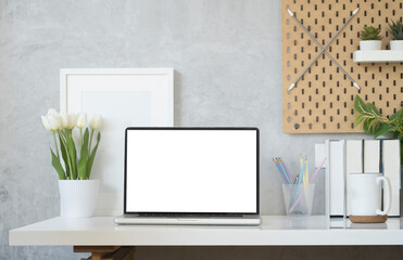 Front view computer laptop with blank screen, flower pot and coffee cup on white table. Blank screen for your advertise text.